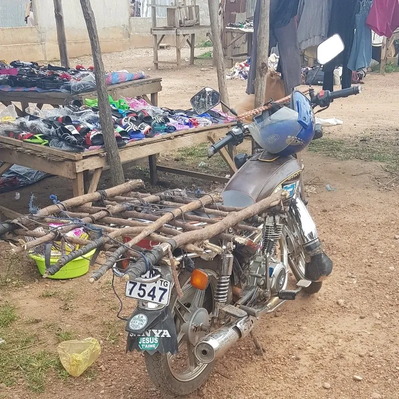 A motorbike with a cargo bed near the market