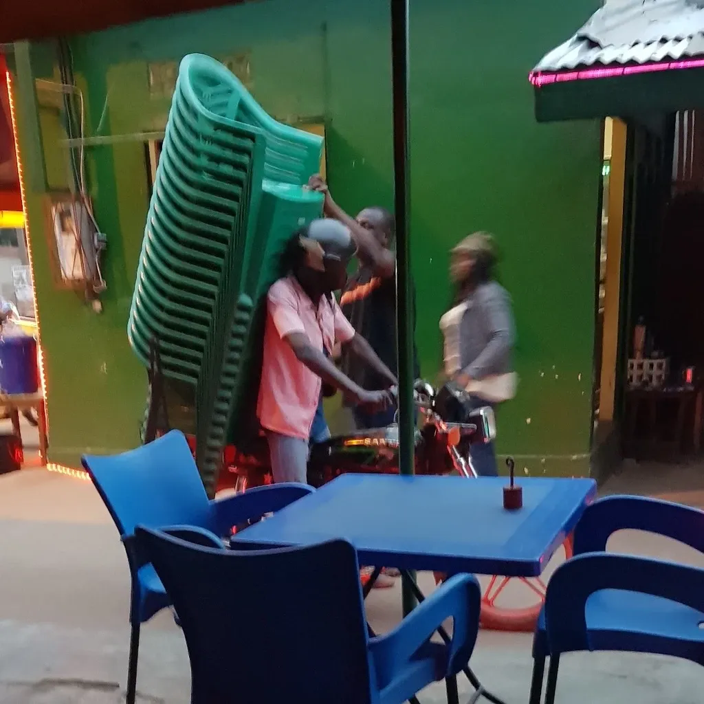 Chairs being delivered to a bar, by motorbike of course