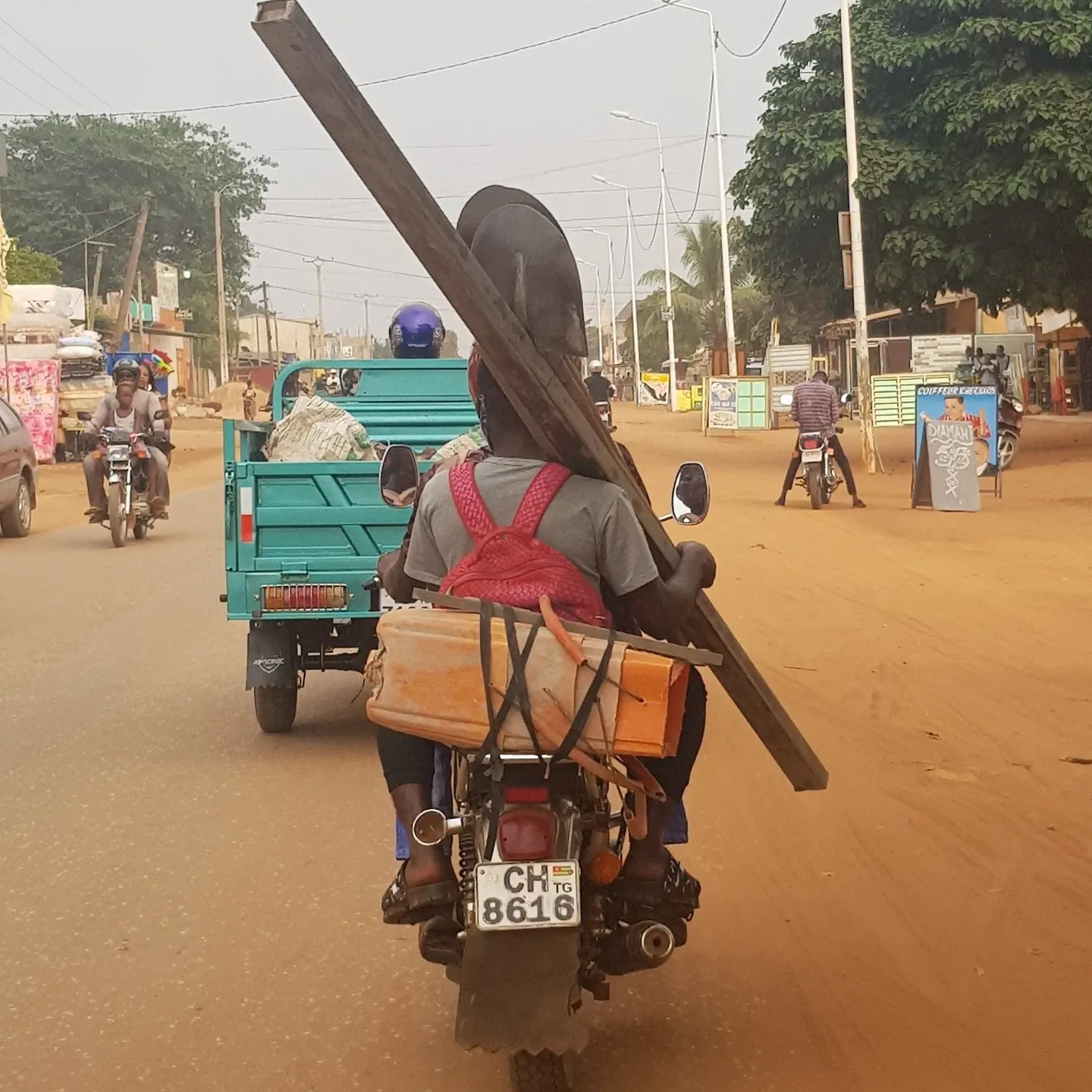 A mason on his way to work by moto-taxi