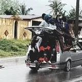 A taxi at full capacity, I counted about 20 people