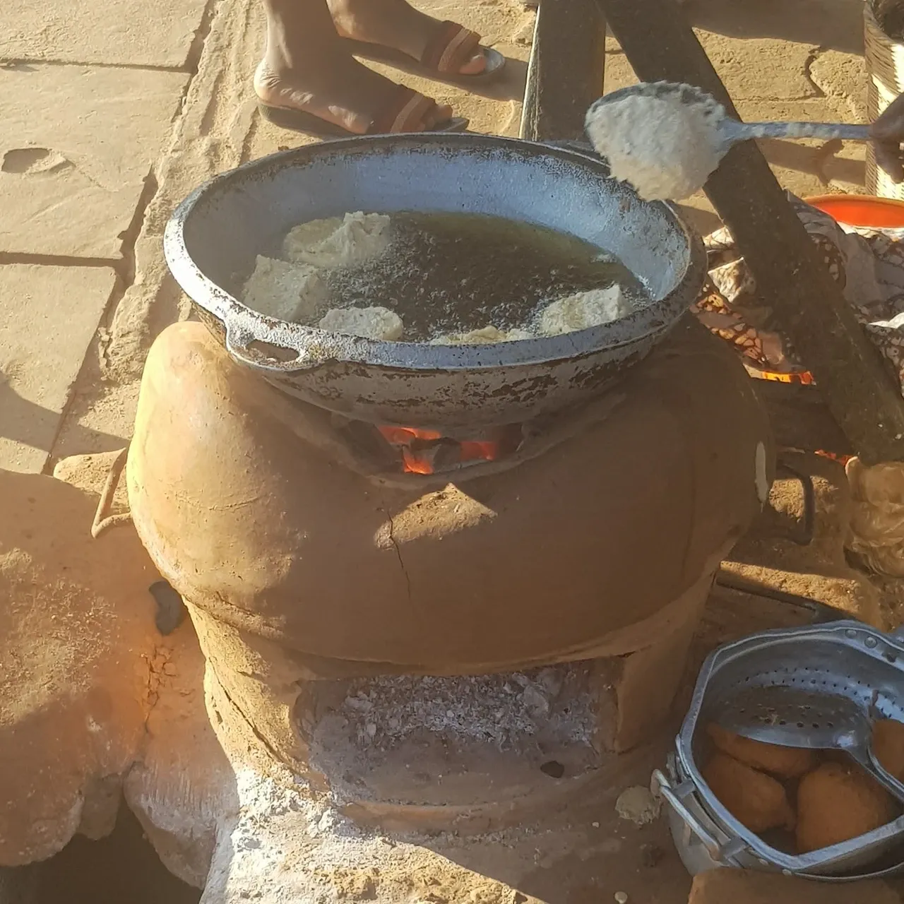 Charcoal is used for cooking almost everywhere, here deep-fried dumplings made of bean flour